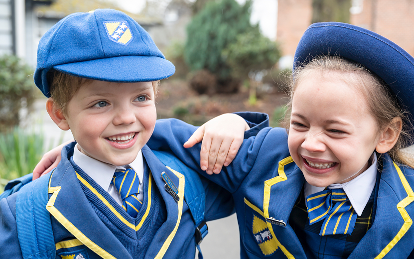 Two school pupils embracing